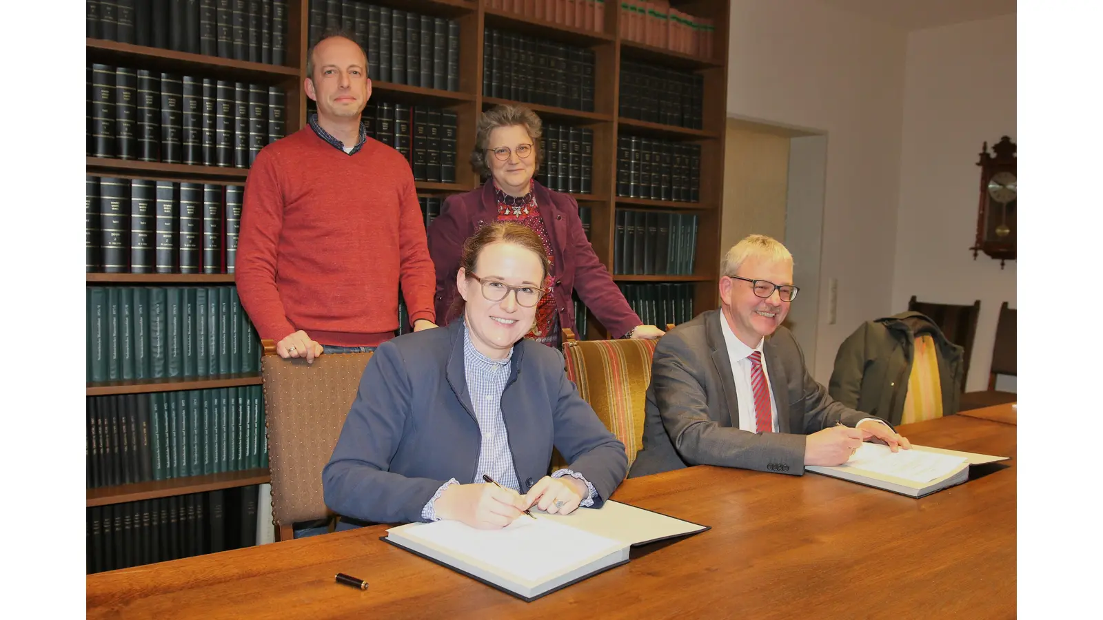 Aileen Borschke, Bürgermeisterin der Samtgemeinde Niedernwöhren, und Ditma Köritz, Bürgermeister der Samtgemeinde Nienstädt, unterschreiben im Beisein der Verwaltungsmitarbeiter Sebastian Kühn und Sandra Wiechmann die Zweckvereinbarung zur engen Zusammenarbeit.  (Foto: Borchers, Bastian)